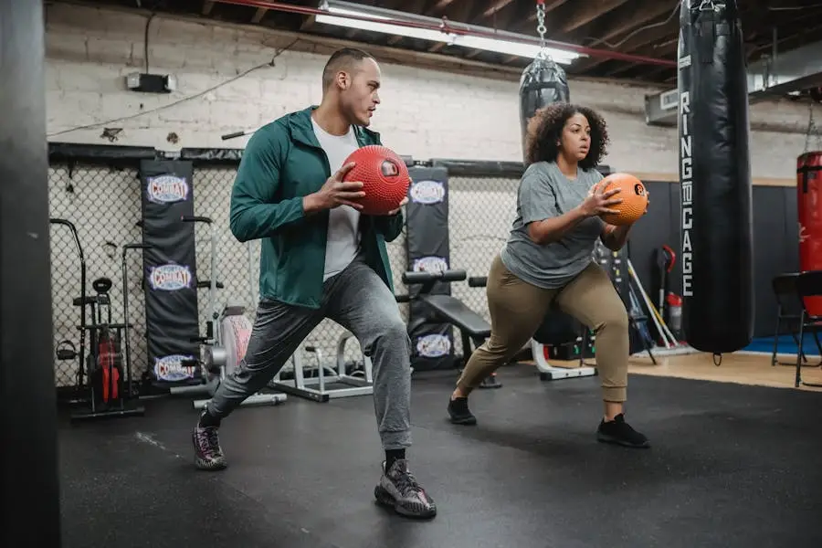 Full body of experienced instructor doing exercises with African American overweight woman in gym